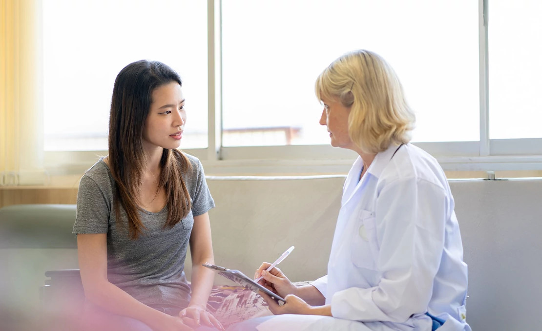female patient and female doctor talking female patient and female doctor talking