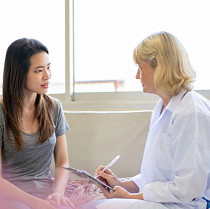 female patient and female doctor talking