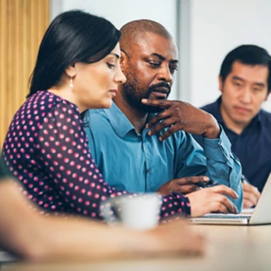 co-workers-working-on-a-laptop-during-a-conference