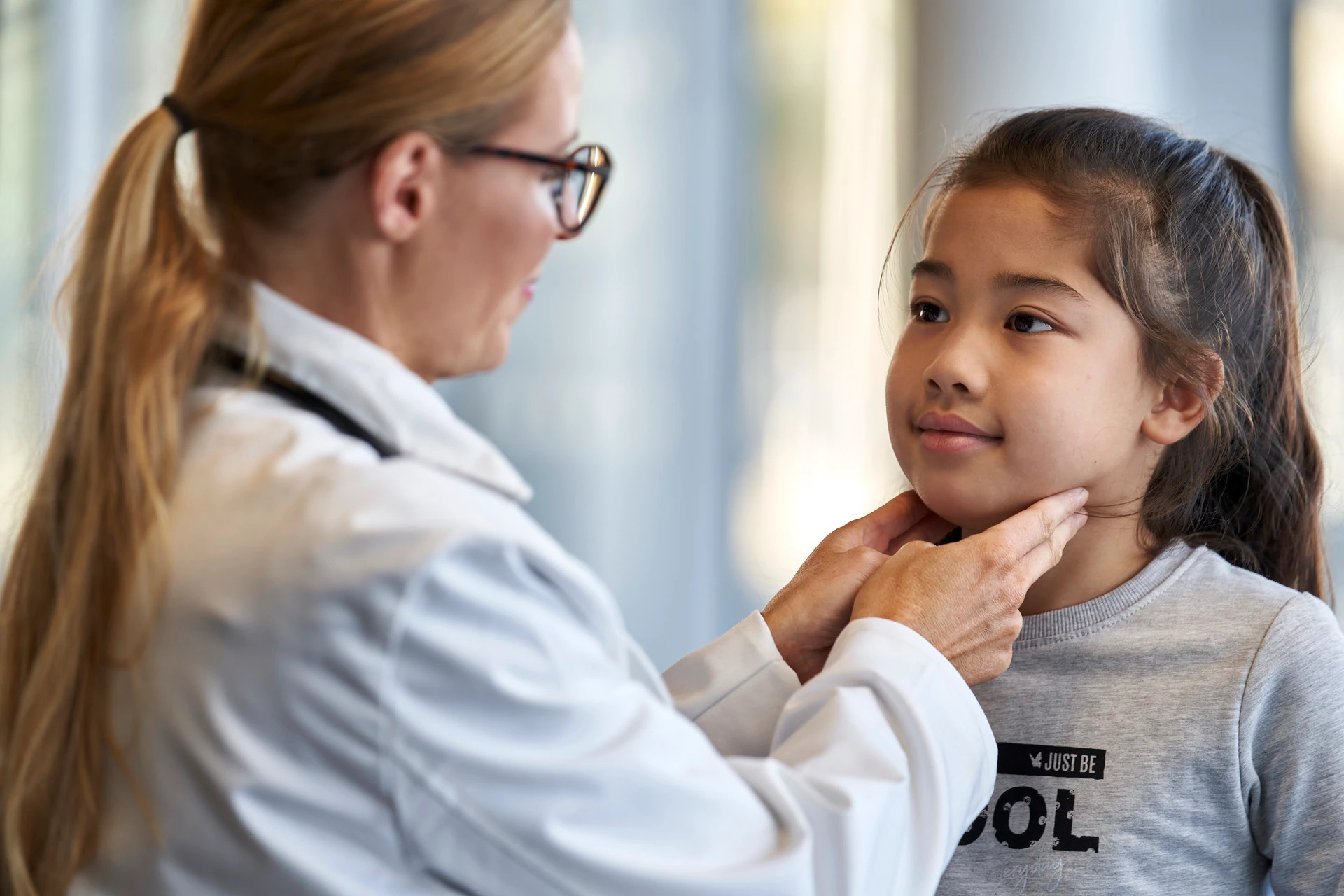 Dr checks child's glands Dr checks child's glands