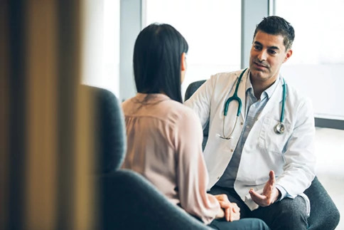 female patient chatting informally to doctor female patient chatting informally to doctor