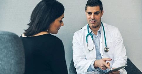 smiling-male-doctor-with-patient smiling-male-doctor-with-patient